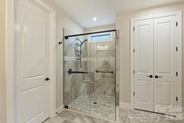 a bathroom with a glass shower door
