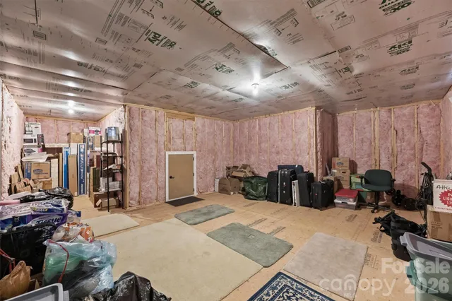 a bed room with a bed a couch and a large window