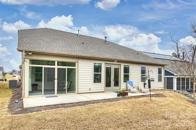 a view of a swimming pool with a lawn chairs under an umbrella