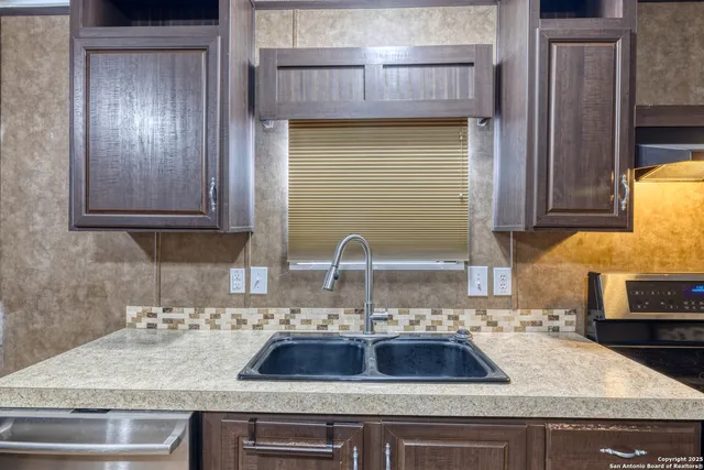 a kitchen with sink and cabinets