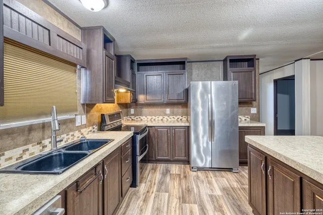 a kitchen with a sink stove and refrigerator