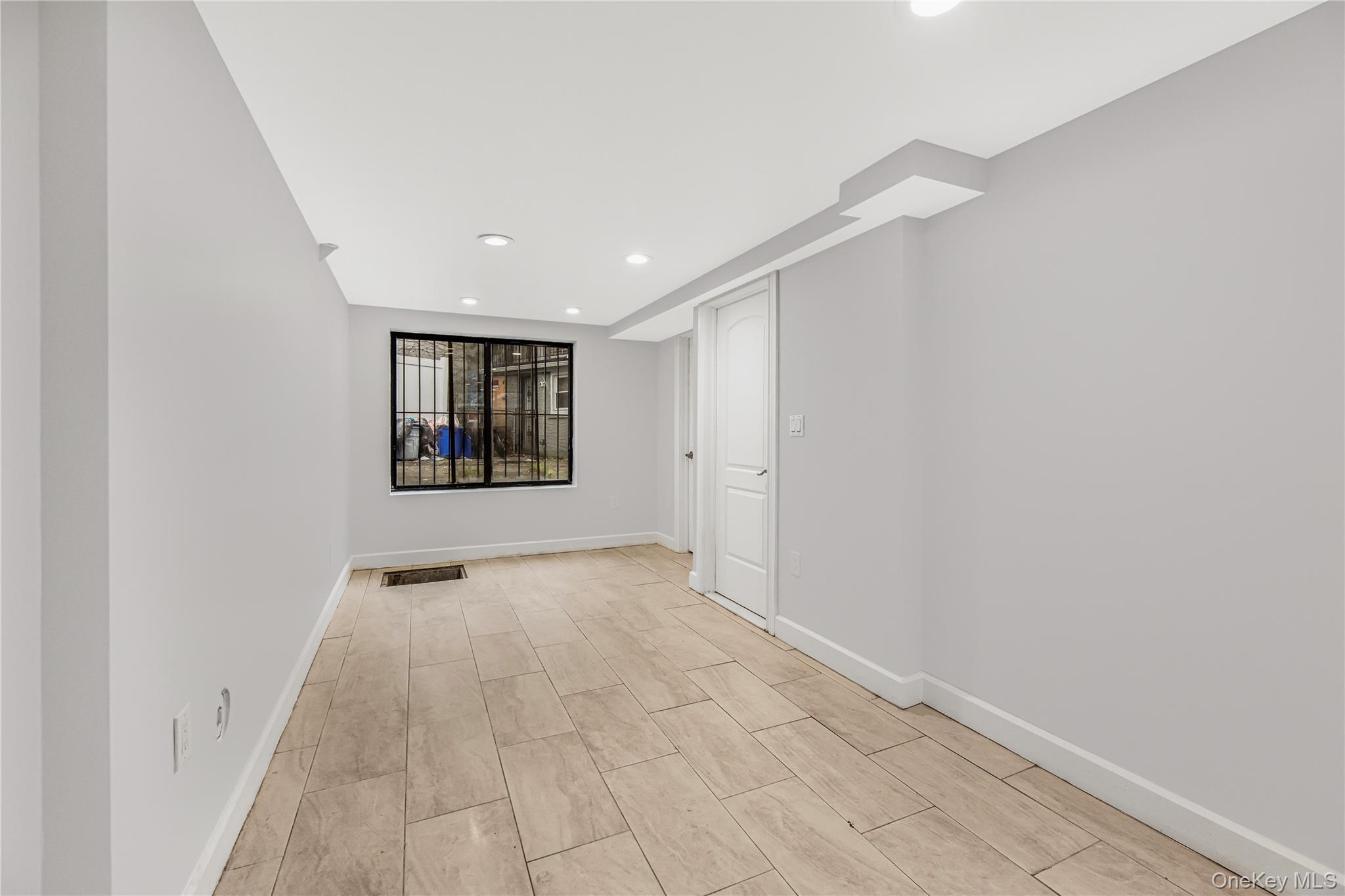 3067 Williamsbridge Road Bronx, NY 10467 - Photo 20 of 29 wooden floor in an empty room with a window