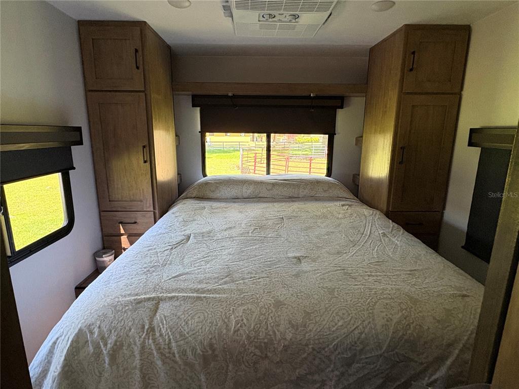 1575 Northeast 100th Street Anthony, FL 32617 - Photo 26 of 29 a bed sitting in a bedroom next to a window