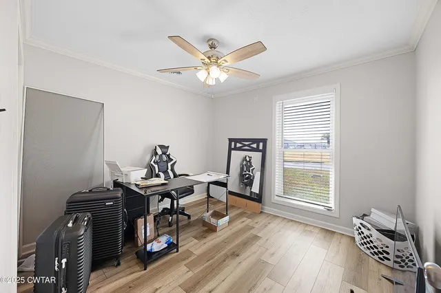 a view of a workspace with furniture and a window