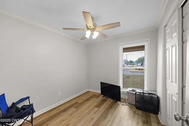 a view of workspace with wooden floor and ceiling fan