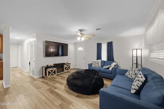 a living room with furniture and a flat screen tv