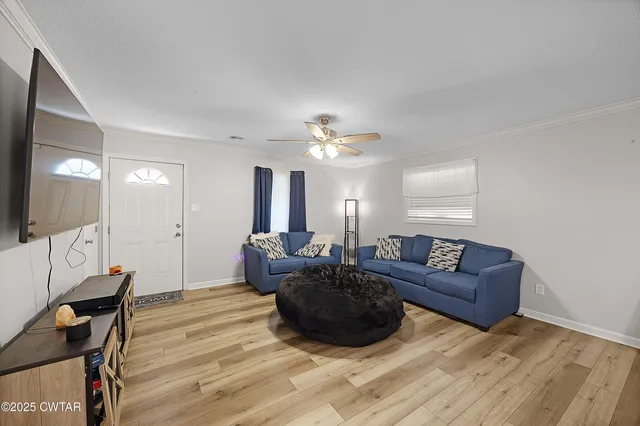 a living room with furniture and a chandelier