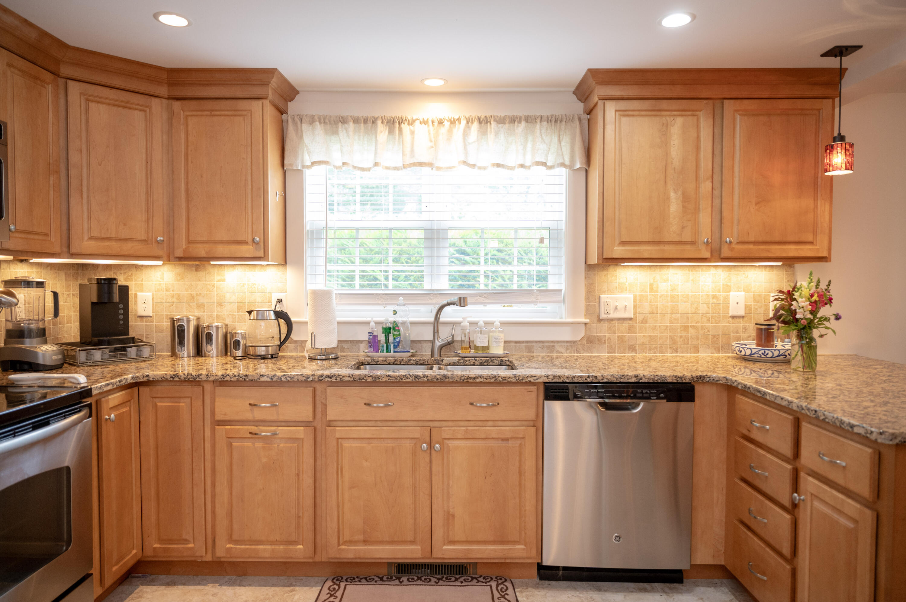 46 Bournedale Road Buzzards Bay, MA 02532 - Photo 20 of 46 a kitchen with granite countertop wooden cabinets stainless steel appliances a sink and a window