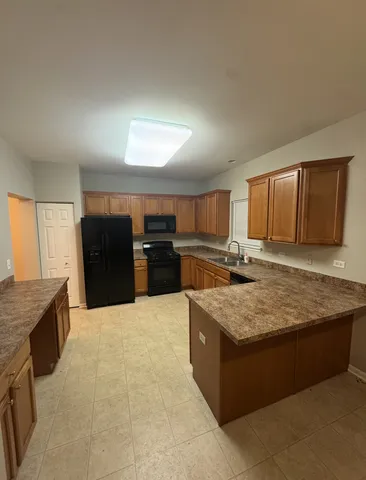 a living room with granite countertop furniture and kitchen view