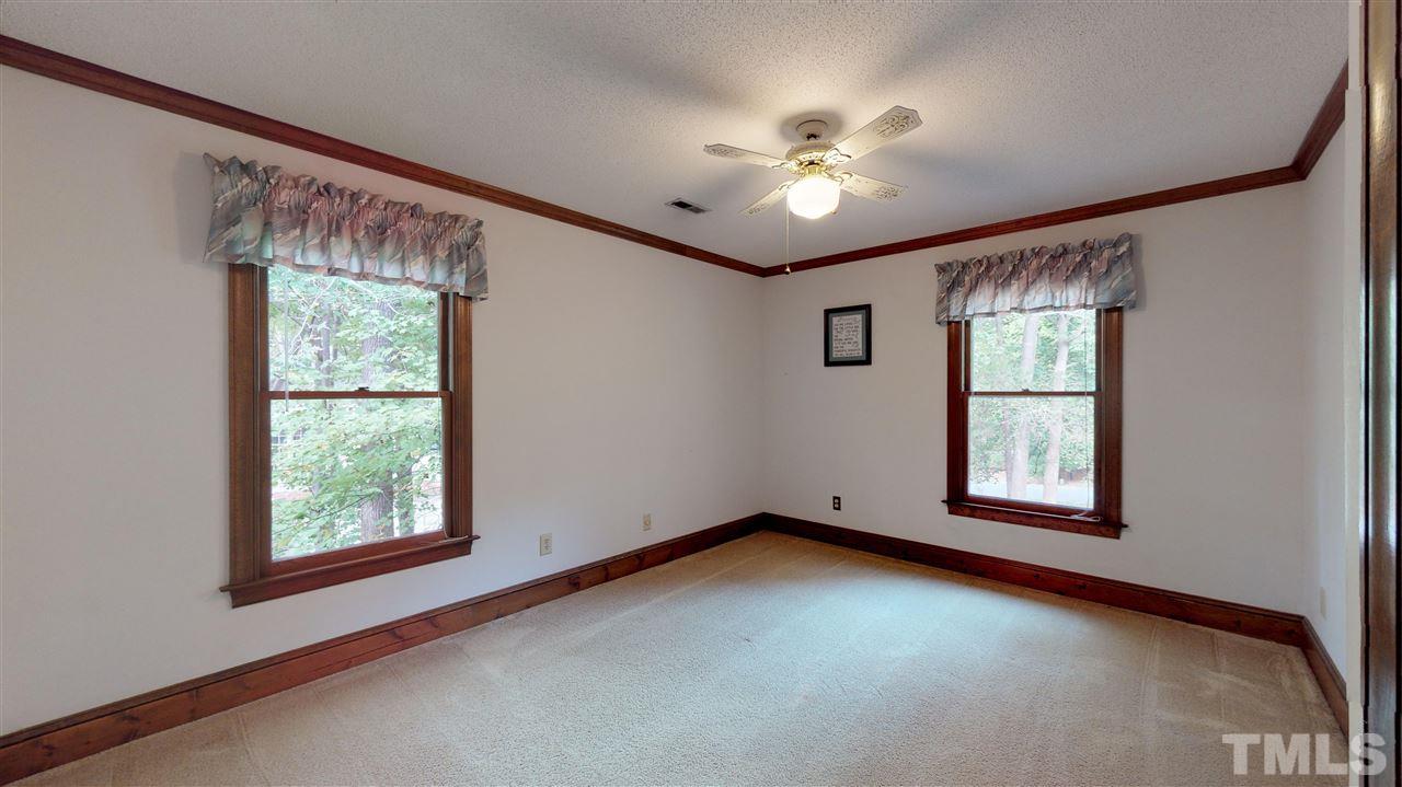 805 Brookfield Road Raleigh, NC 27615 - Photo 14 of 27 a view of a big room with windows and chandelier fan