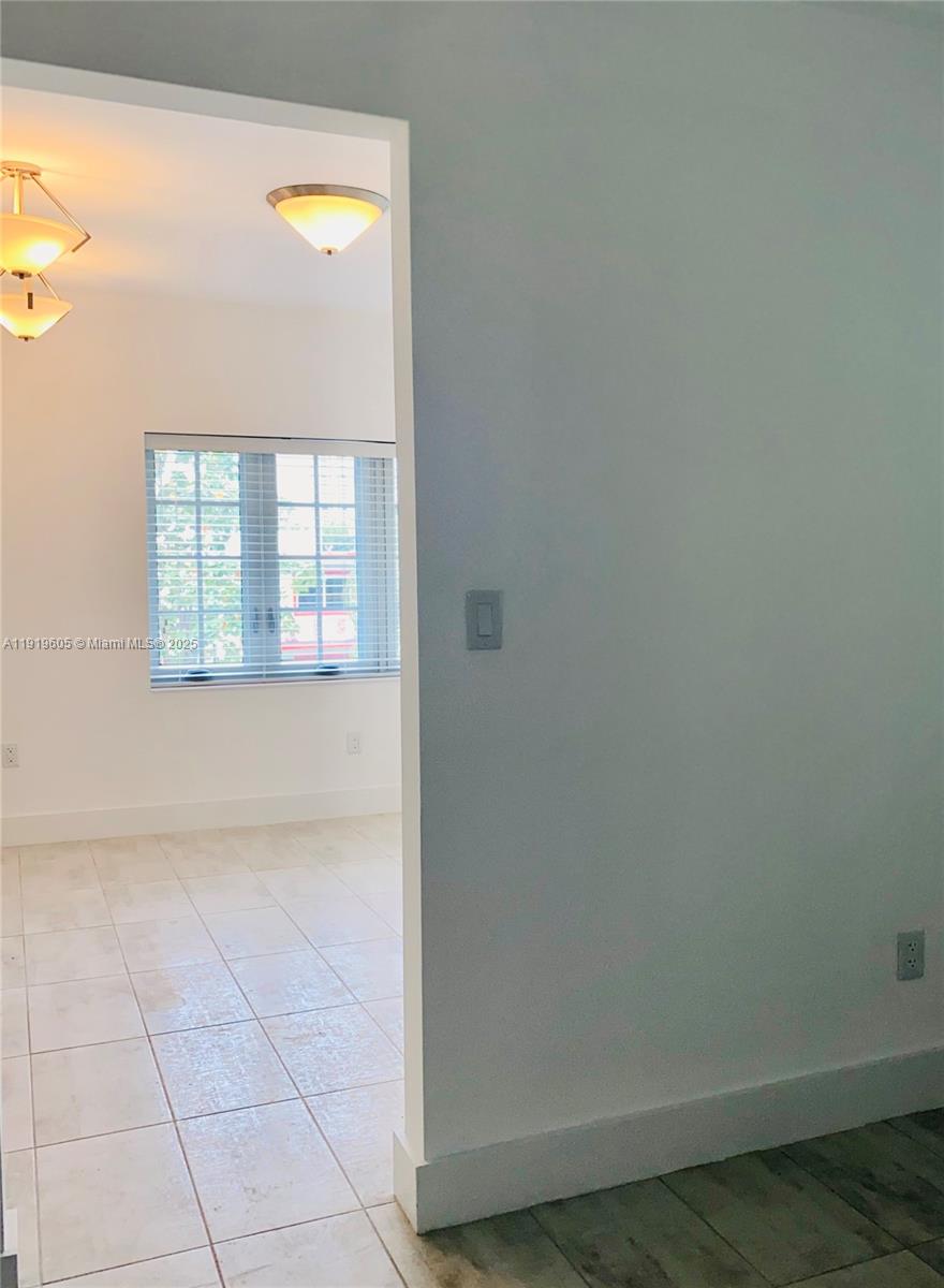 1201 Pennsylvania Avenue, Unit 206 Miami Beach, FL 33139 - Photo 4 of 9 a view of an empty room with a window