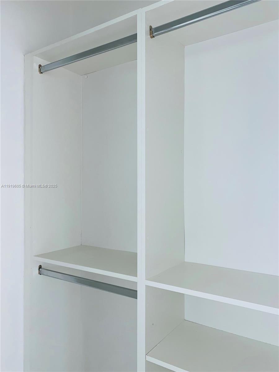 1201 Pennsylvania Avenue, Unit 206 Miami Beach, FL 33139 - Photo 5 of 9 a bathroom with a glass shower door