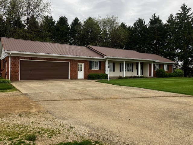 4015 East 1st Road Mendota, IL 61342 - Photo 2 of 45 a front view of a house with a yard and trees