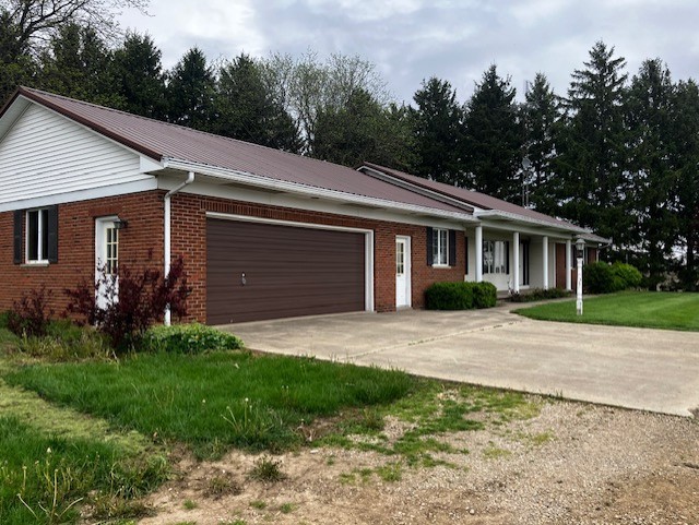 4015 East 1st Road Mendota, IL 61342 - Photo 32 of 45 a front view of a house with a garden and trees