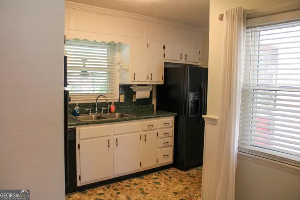a kitchen with stainless steel appliances a stove a microwave sink and cabinets
