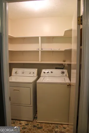 a view of a kitchen with refrigerator and a cabinet