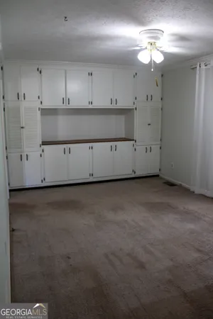 an empty room with windows and closet