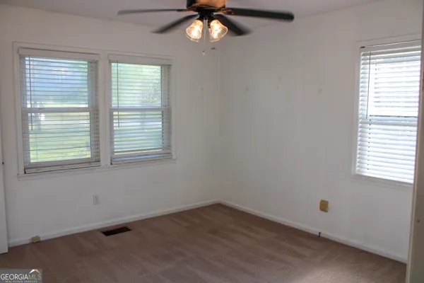 a bathroom with a sink and mirror with toilet