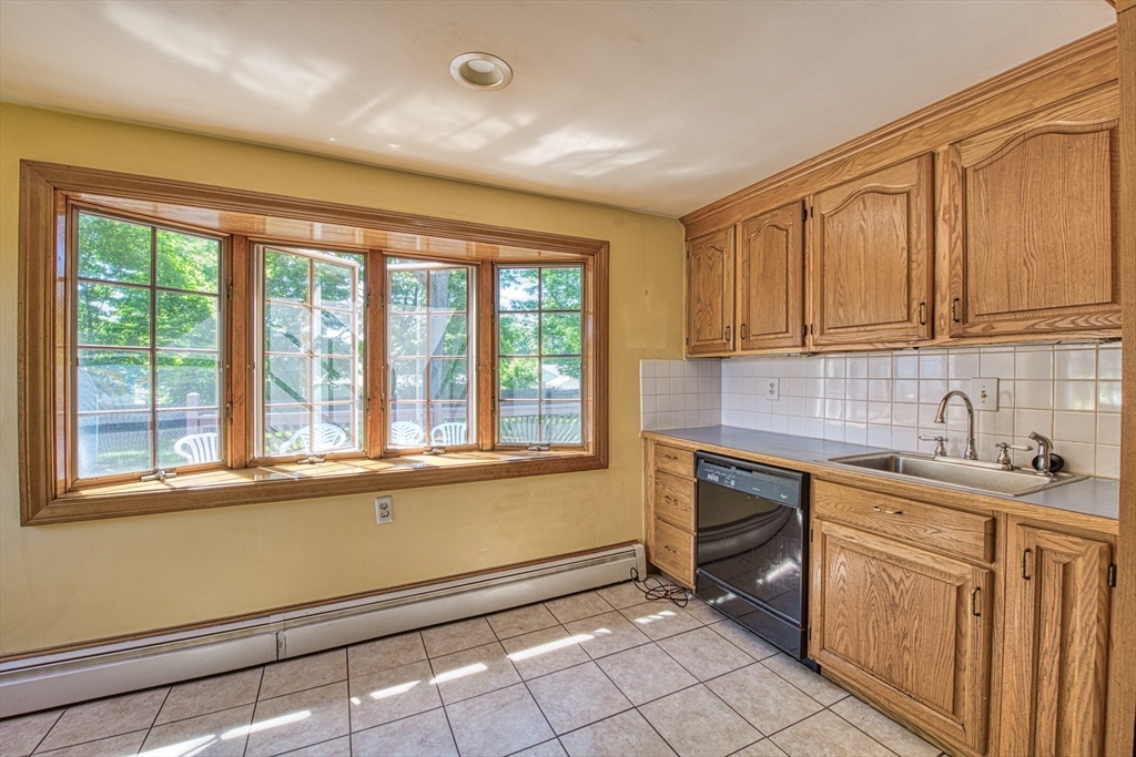 31 Rindone Street Holbrook, MA 02343 - Photo 3 of 23 a kitchen with granite countertop a stove sink and cabinets
