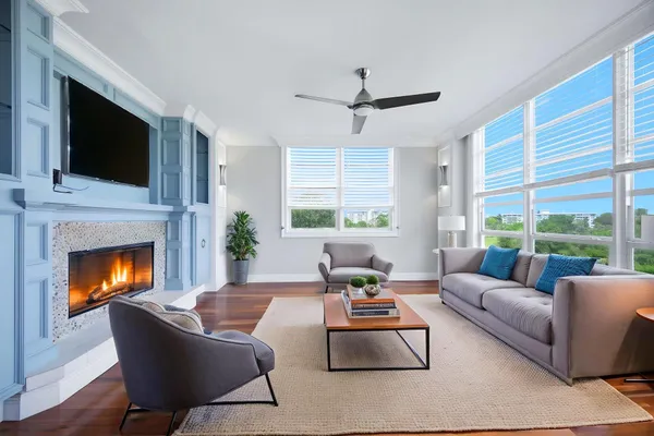 a living room with furniture fireplace and flat screen tv