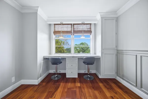 a view of workspace with wooden floor and windows
