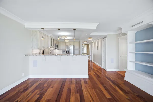 a view of kitchen with wooden floor and electronic appliances