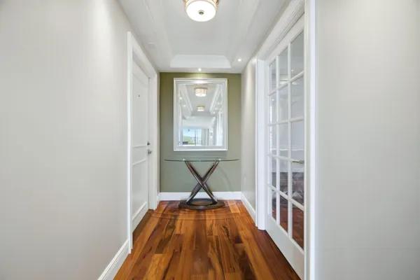 a view of a bedroom with wooden floor and a window
