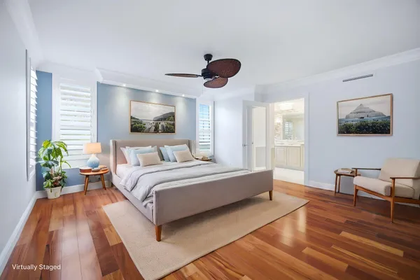 a spacious bedroom with a bed and a chandelier