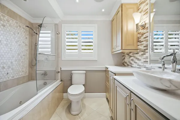 a bathroom with a sink a toilet and bathtub