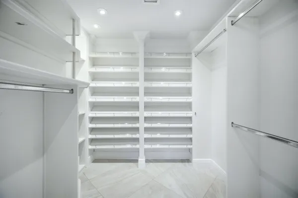 a view of walk in closet with empty racks