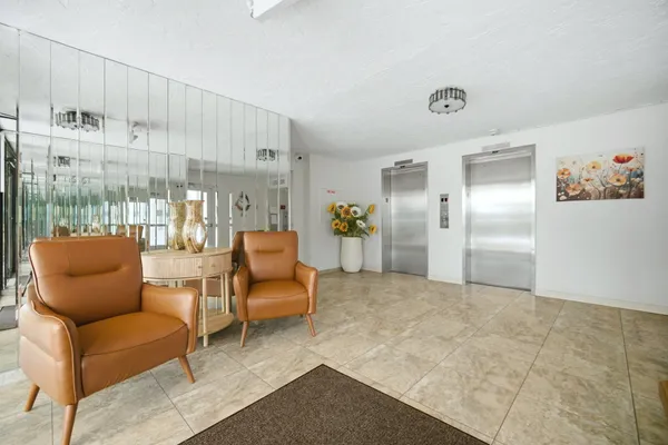 a front view of a building with cars parked