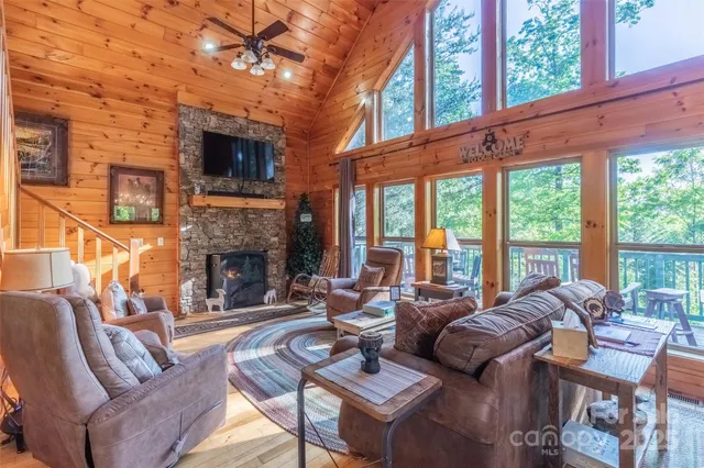 a living room with furniture a fireplace and a flat screen tv