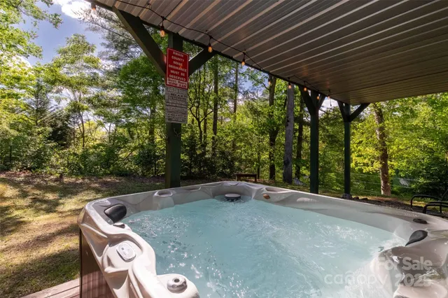 a backyard of a house with trees and outdoor seating