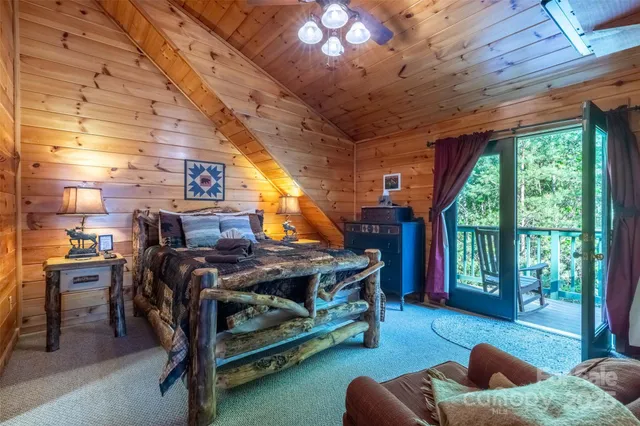 a bedroom with furniture and a large window