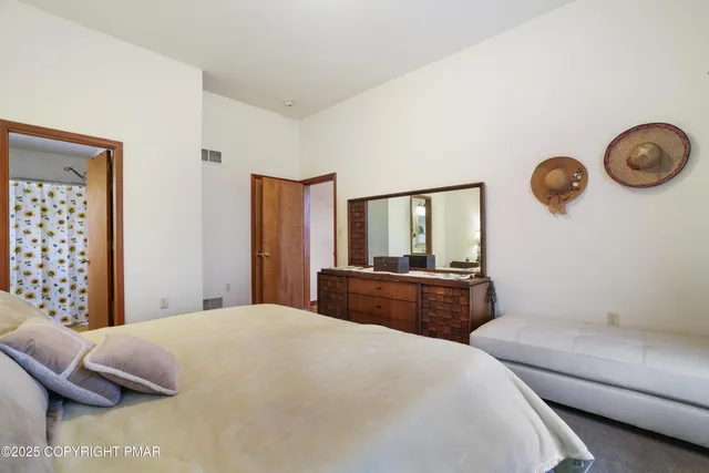 a bedroom with a large bed and a chandelier
