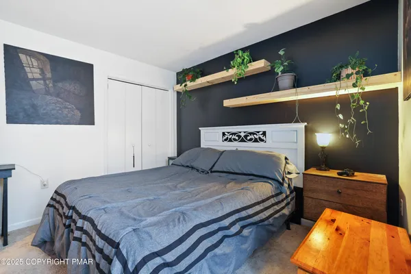 a bedroom with a bed and dresser