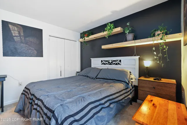 a bedroom with a bed and dresser