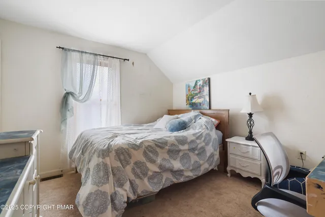 a bedroom with a bed and a chair