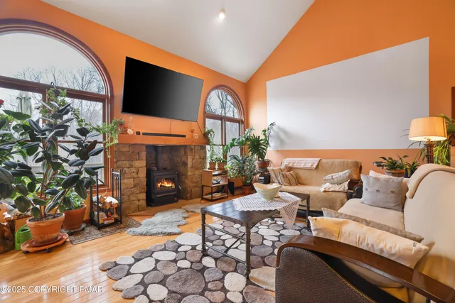 a living room with furniture a fireplace and a flat screen tv