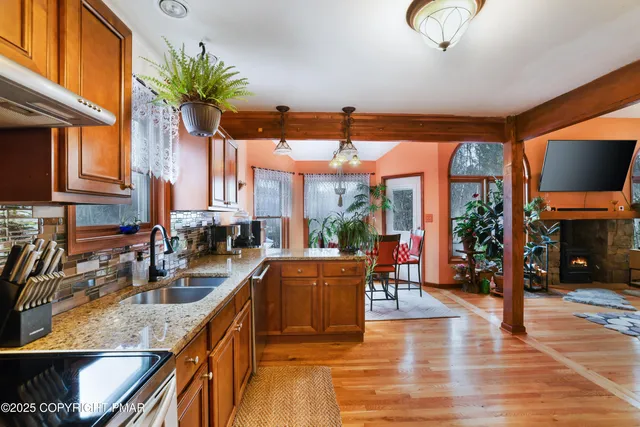 a kitchen with granite countertop lots of counter top space and wooden floor