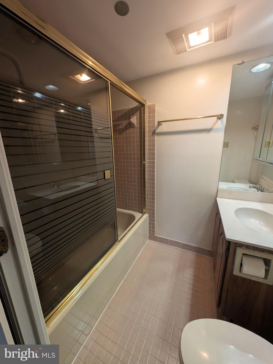 1301 North Courthouse Road, Unit 1202 Arlington, VA 22201 - Photo 8 of 17 a bathroom with a sink a toilet a mirror and shower