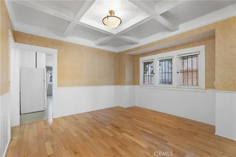a view of a room with wooden floor and windows