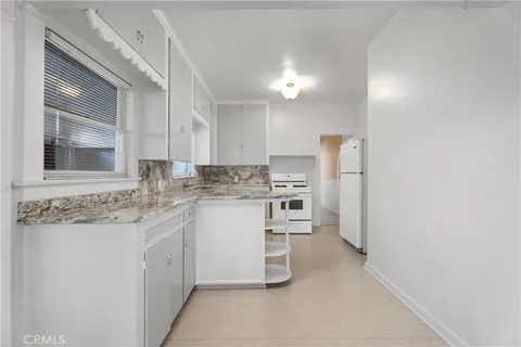 a kitchen with a sink cabinets and window