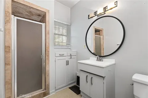 a bathroom with a sink a mirror and a toilet