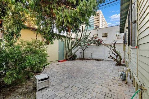 a pathway of a house with a yard