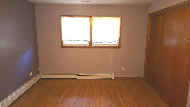 wooden floor and window in an empty room