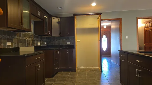 a kitchen with a sink and wooden cabinets