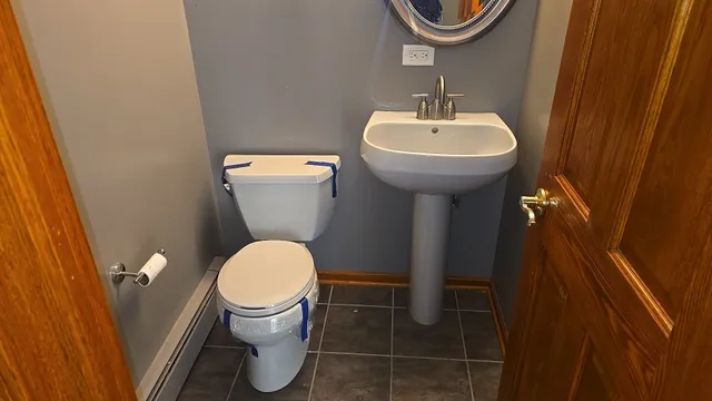 a bathroom with a sink a toilet and a mirror