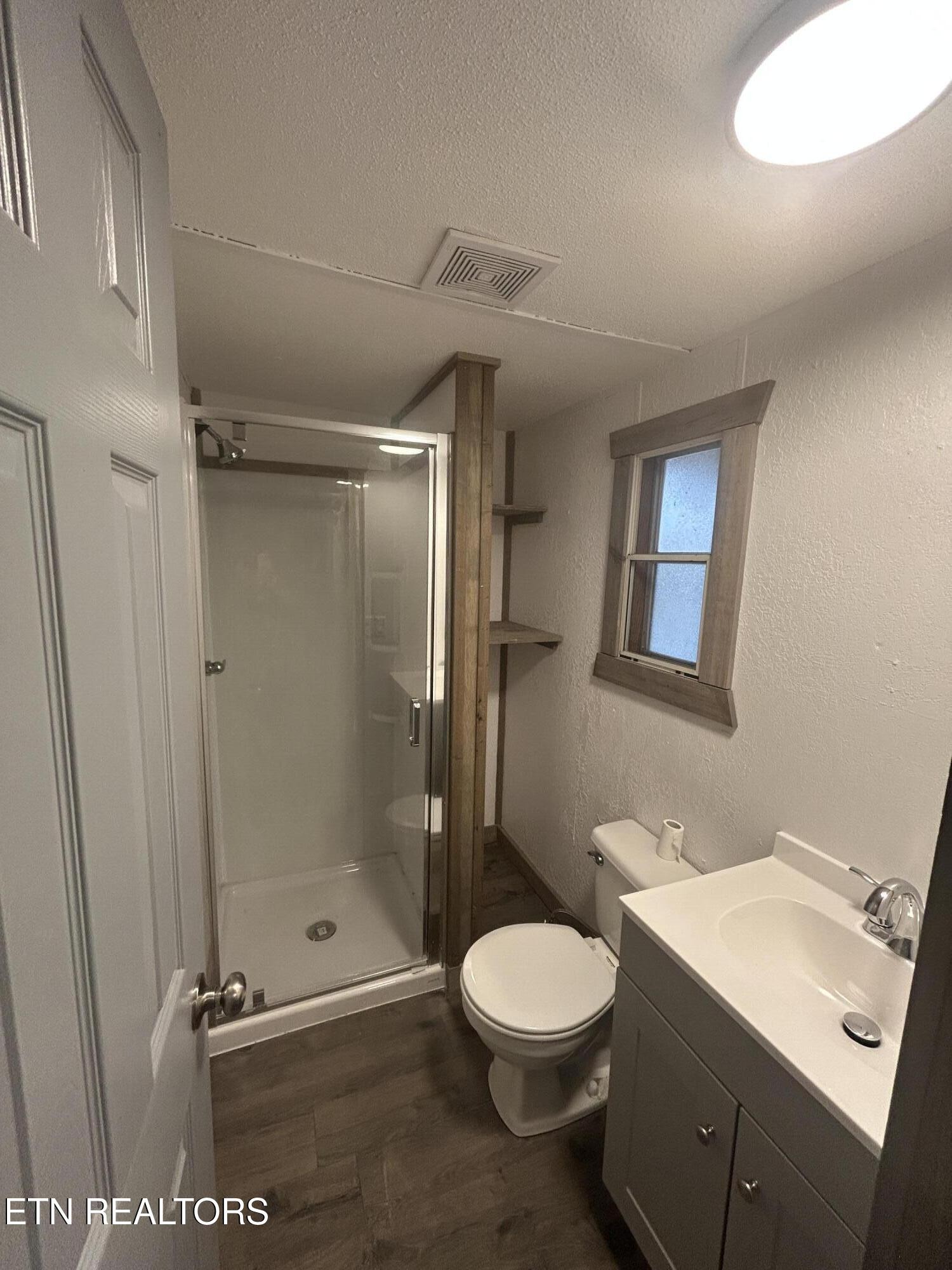 994 Pioneer Road Grimsley, TN 38565 - Photo 15 of 20 a bathroom with a toilet a sink and shower