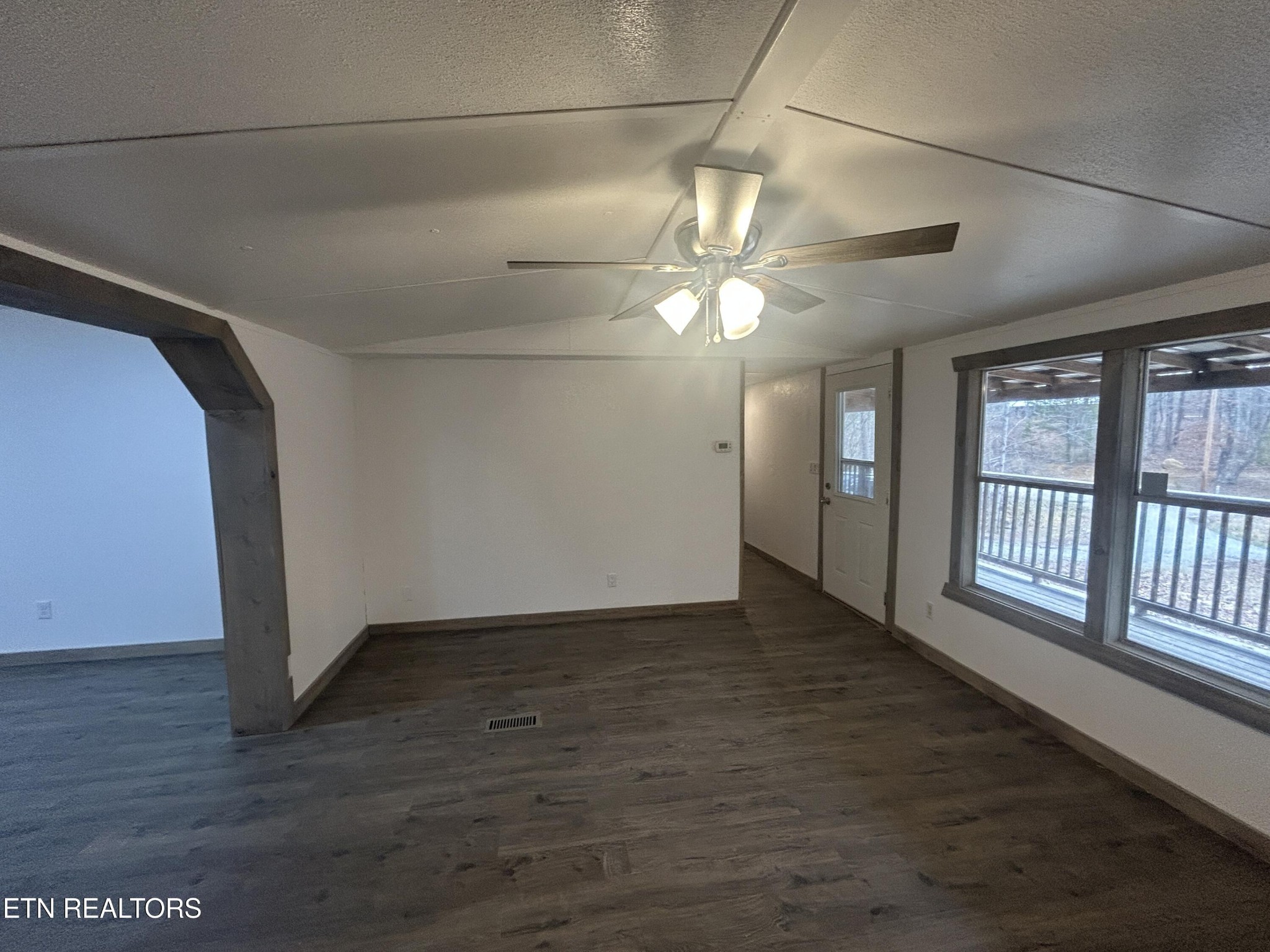 994 Pioneer Road Grimsley, TN 38565 - Photo 6 of 20 a view of an empty room with a window and wooden floor